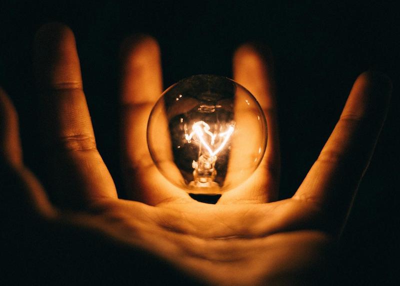 A light bulb in the palm of a hand